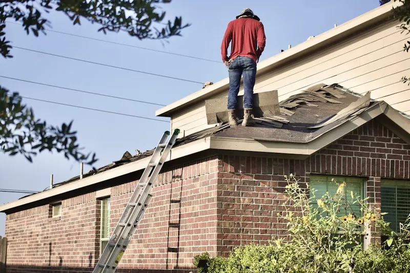 Professional roofer working on a residential roof in Pachaug